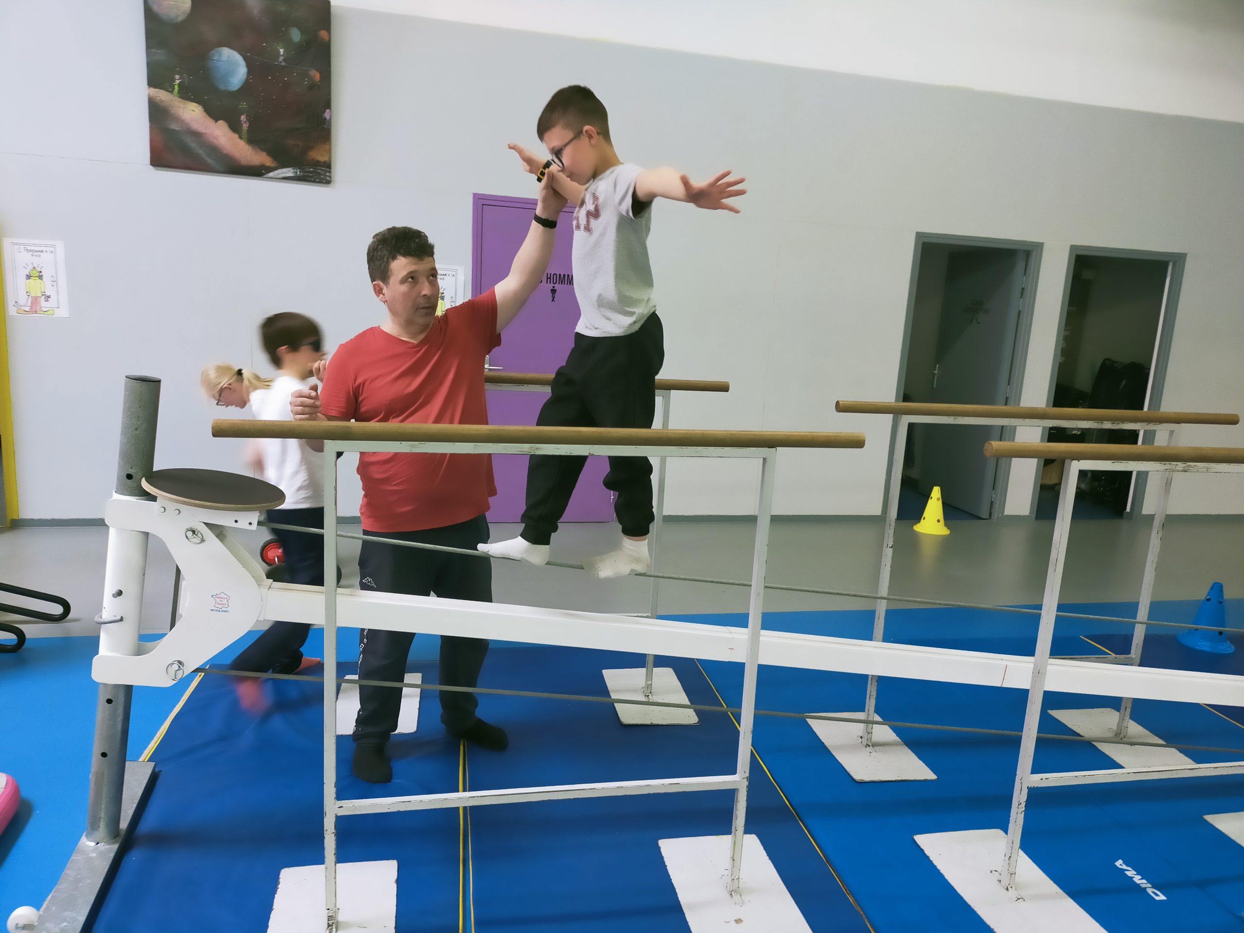 Un jeune marche sur un câble à quelques centimètres du sol